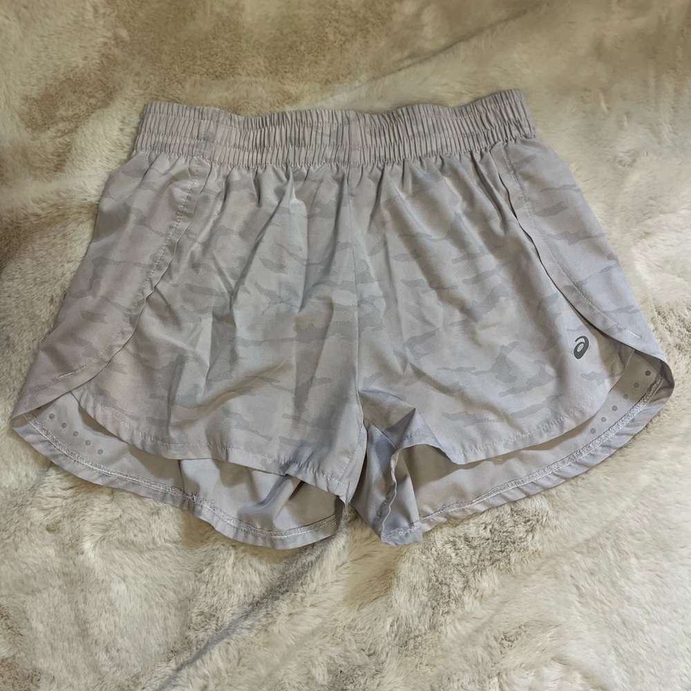 White workout shorts with mesh guard and pocket
